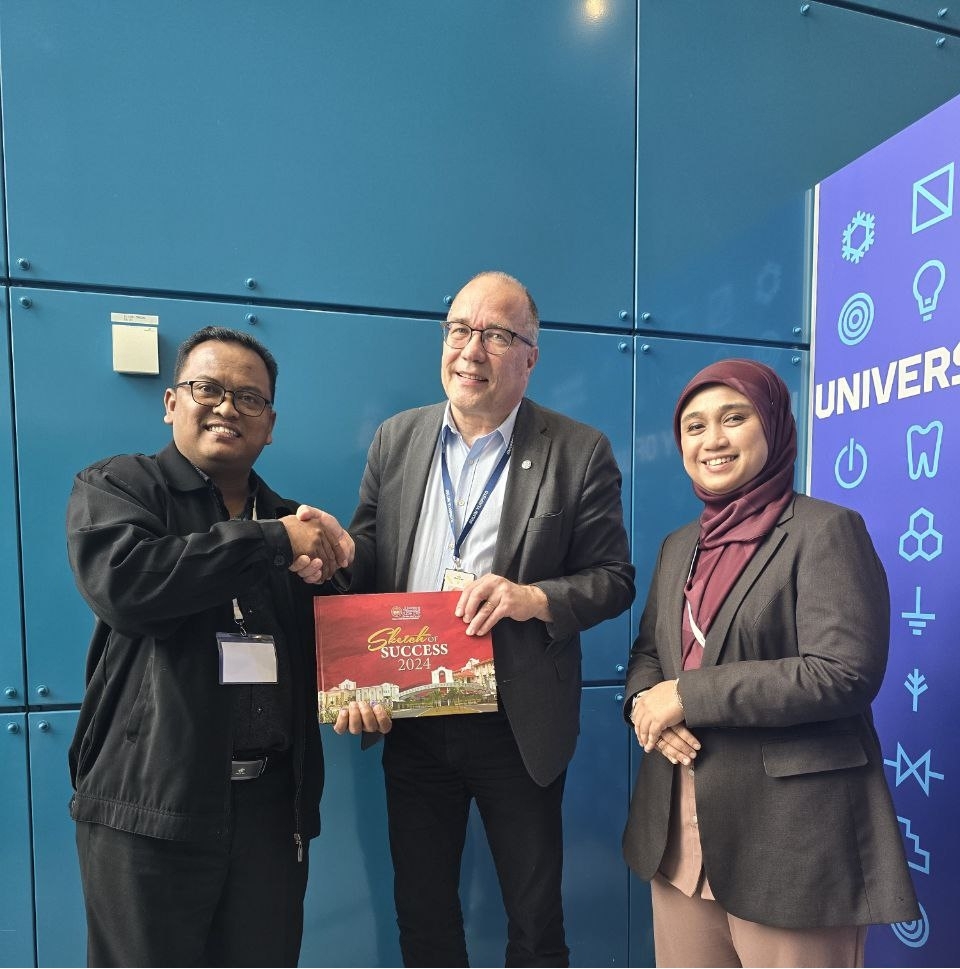 Dr Kama menyampaikan cenderamata kepada Rektor Universiti Oulu, Prof. Arto Maaninen sambil disaksikan Dr Shakila Che Dahalan.